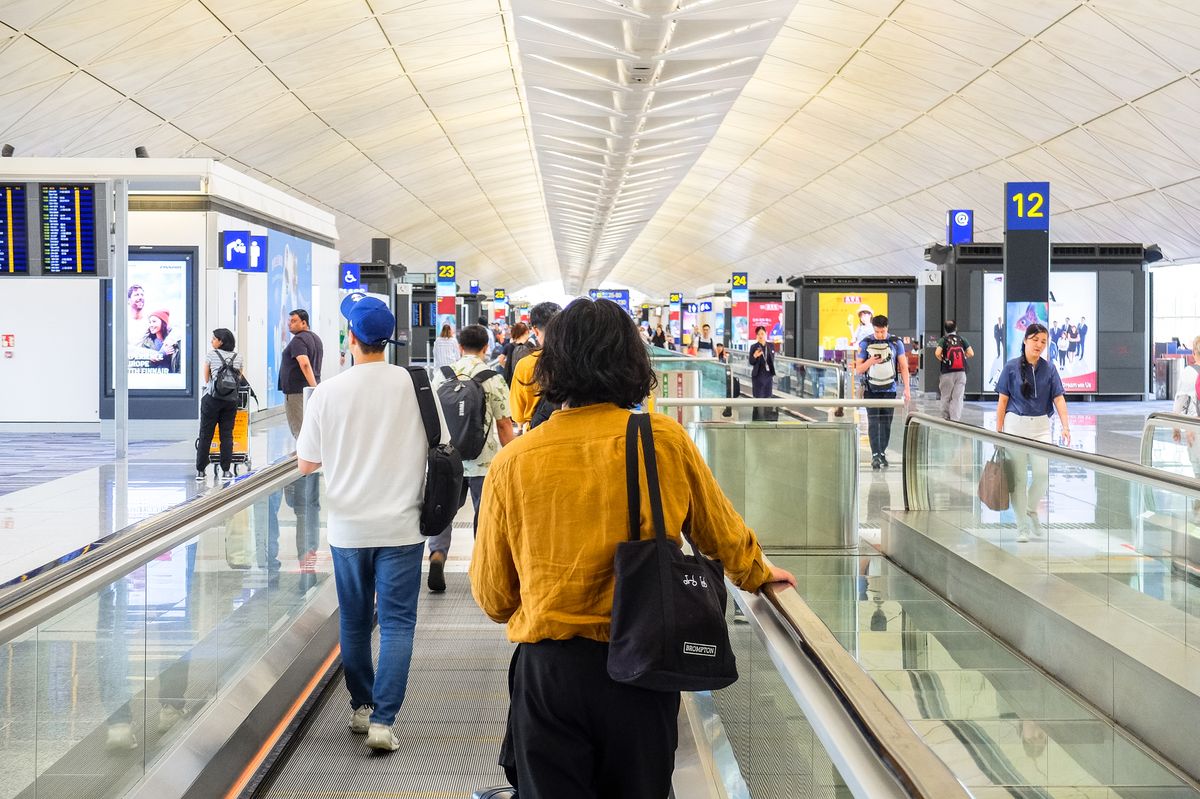 Passengers walking through an airport terminal